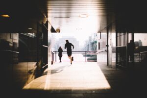Keep Informative | A Man Running On A Hallway Towards A Girl