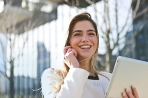 Customer Service | A Girl Smiling while Talking On The Phone 