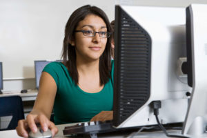 Woman at computer getting ppc and seo certifications 