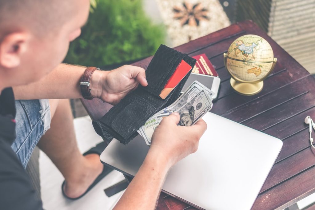 Man Pulling Cash Out Of Wallet 