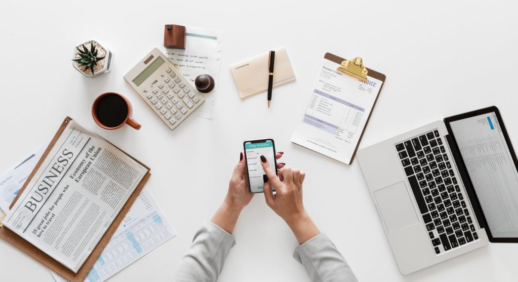 woman at desk surrounded by work items