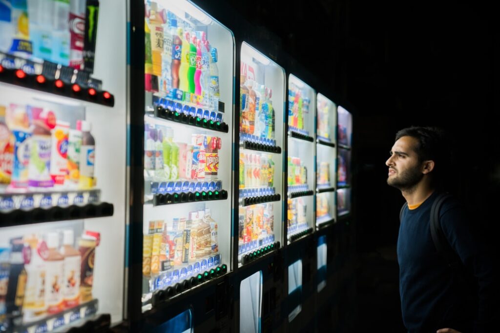 man in front of vending machines at night