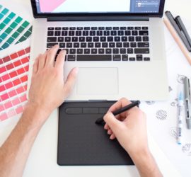web designer with color palettes and computer in front of him