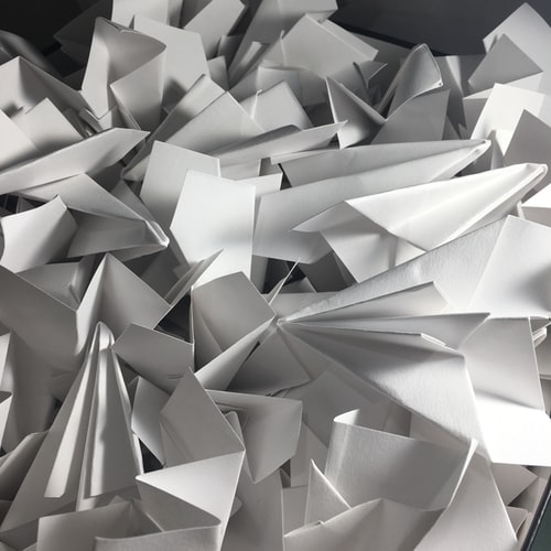 paper airplanes in a pile