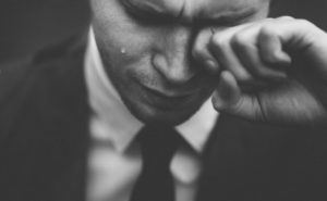 man in suit crying 