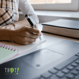 Content Writing | A Girl Writing On A Notebook In front Of A Laptop