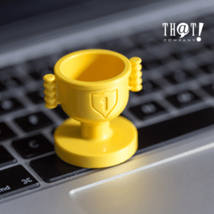 Benefits of SEO | A Yellow Toy Trophy at the Top of A Laptop