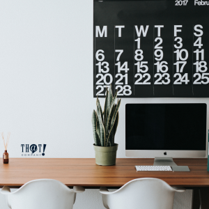 It Is Not Just About Work | A Minimalist Layout Of Workspace With Plant on the Side and Big Black & White Calendar At The Wall