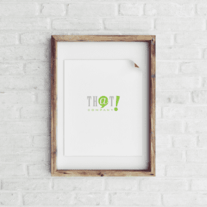 Focus On The Content | A Clean Wooden Picture Frame With That!Company Logo Hanged In A White Bricked Wall 