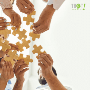 Team Building | A Group Of People Holding A Piece Of Puzzle