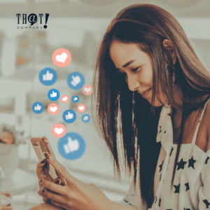 Use Social Media For Blogs | A Girl Holding Her Phone With Floating Icons Of Like And Heart Reactions For Facebook